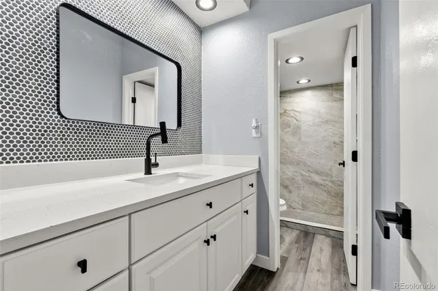 a white toilet sitting next to a shower