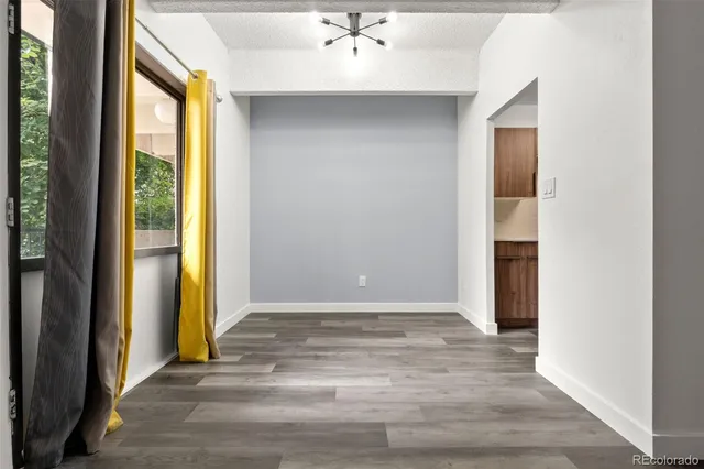 a view of an empty room and wooden floor