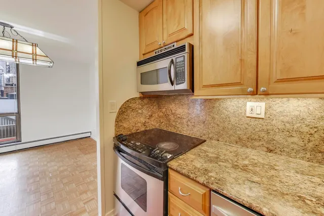a kitchen with granite countertop a sink and a stove