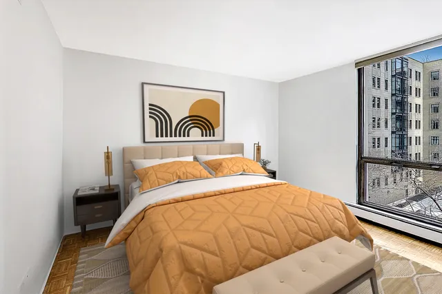 a bedroom with a bed and painting on the wall