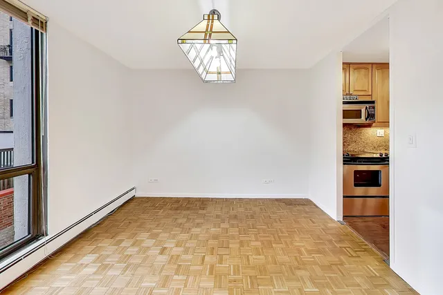 en empty room with wooden floor and white walls