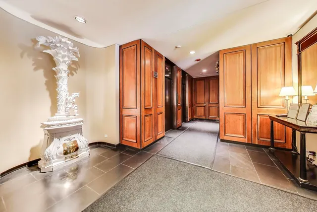 a view of a room with furniture and a chandelier