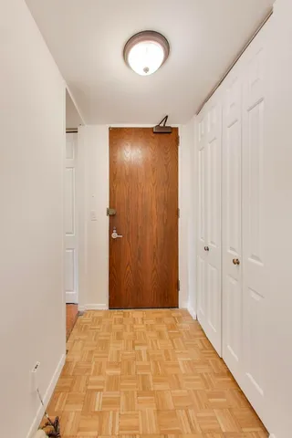 a view of a big room with wooden floor and closet
