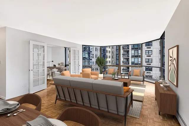 a living room with furniture and a floor to ceiling window