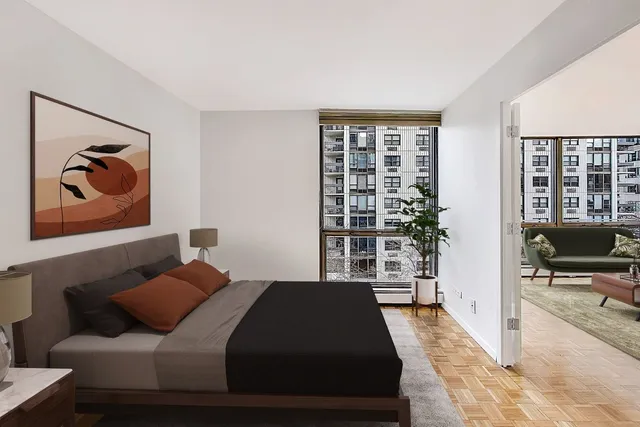 a bedroom with a bed and glass door