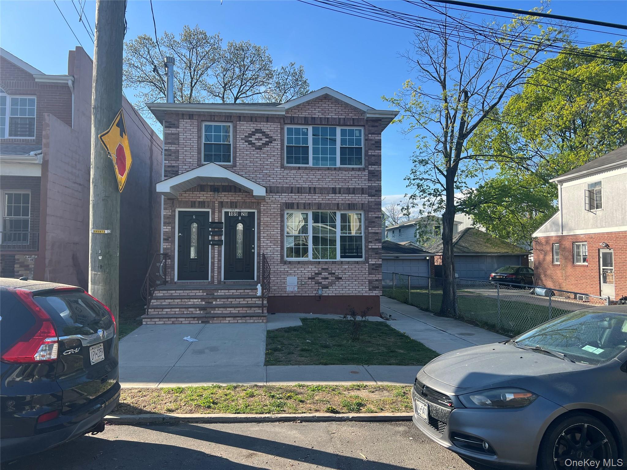 189-20 117th Road Queens, NY 11412 - Photo 1 of 26 a front view of a house with garden