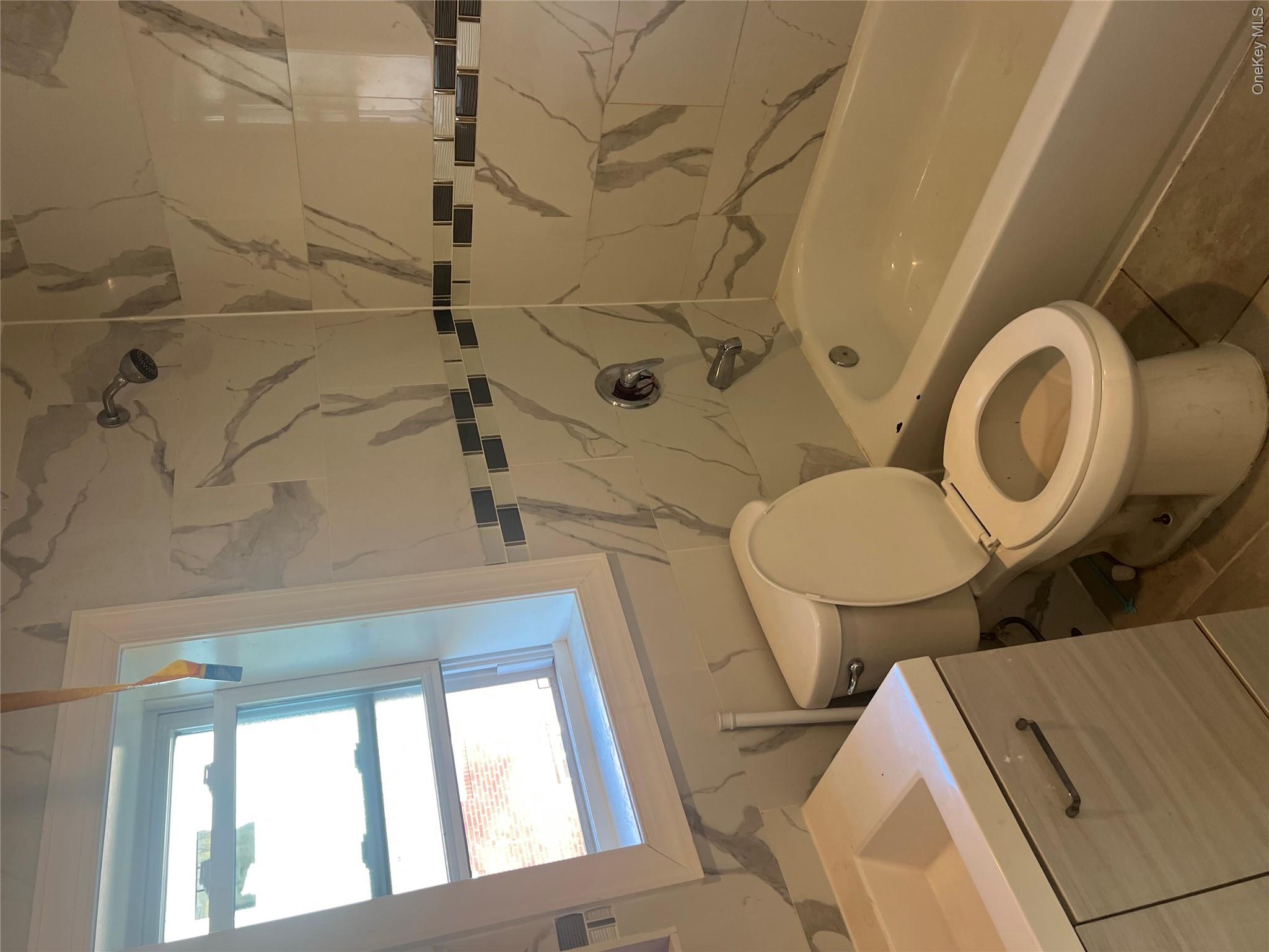 189-20 117th Road Queens, NY 11412 - Photo 15 of 26 a bathroom with a sink a toilet and bathtub
