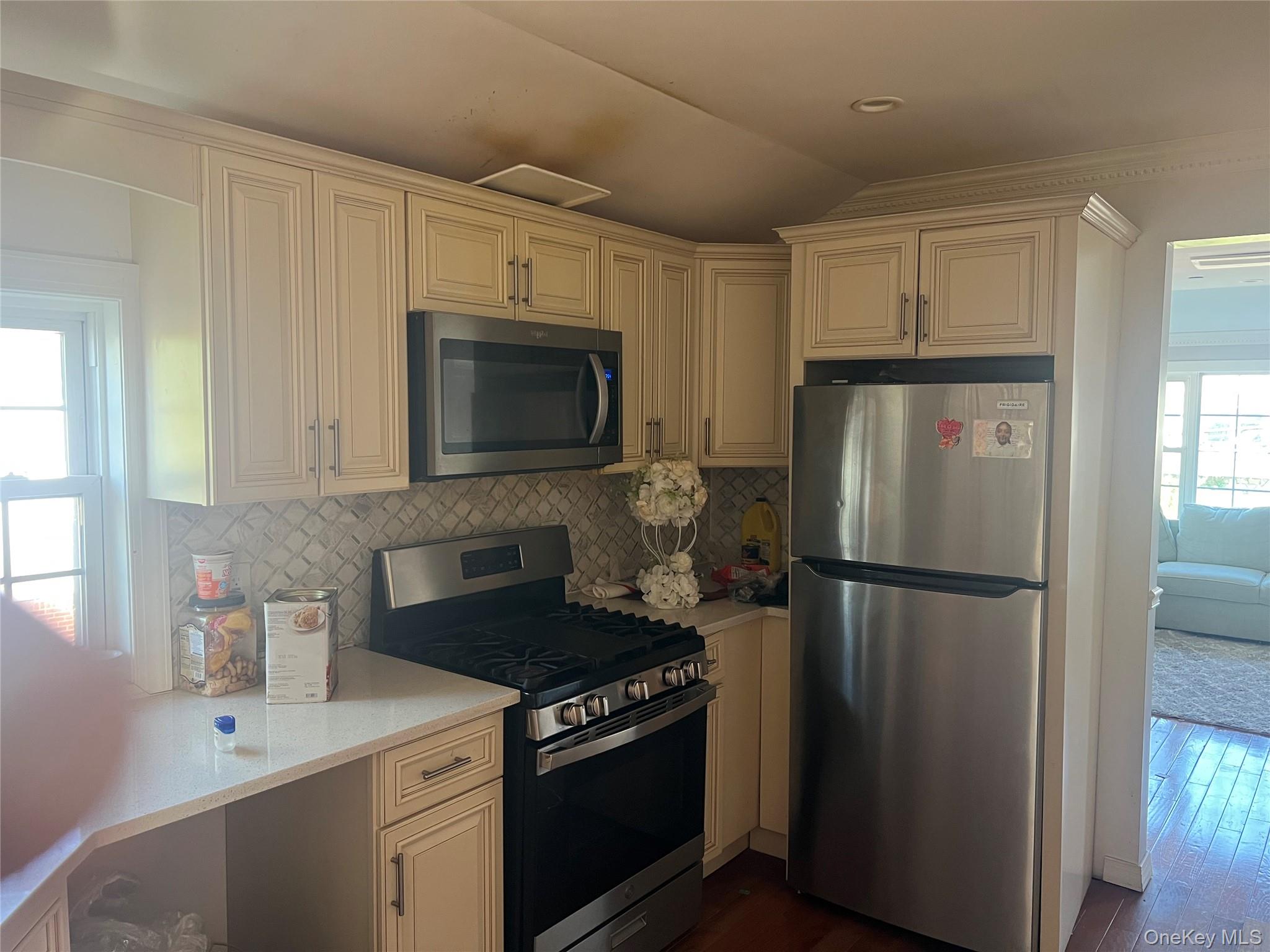 189-20 117th Road Queens, NY 11412 - Photo 19 of 26 a kitchen with a refrigerator stove and microwave