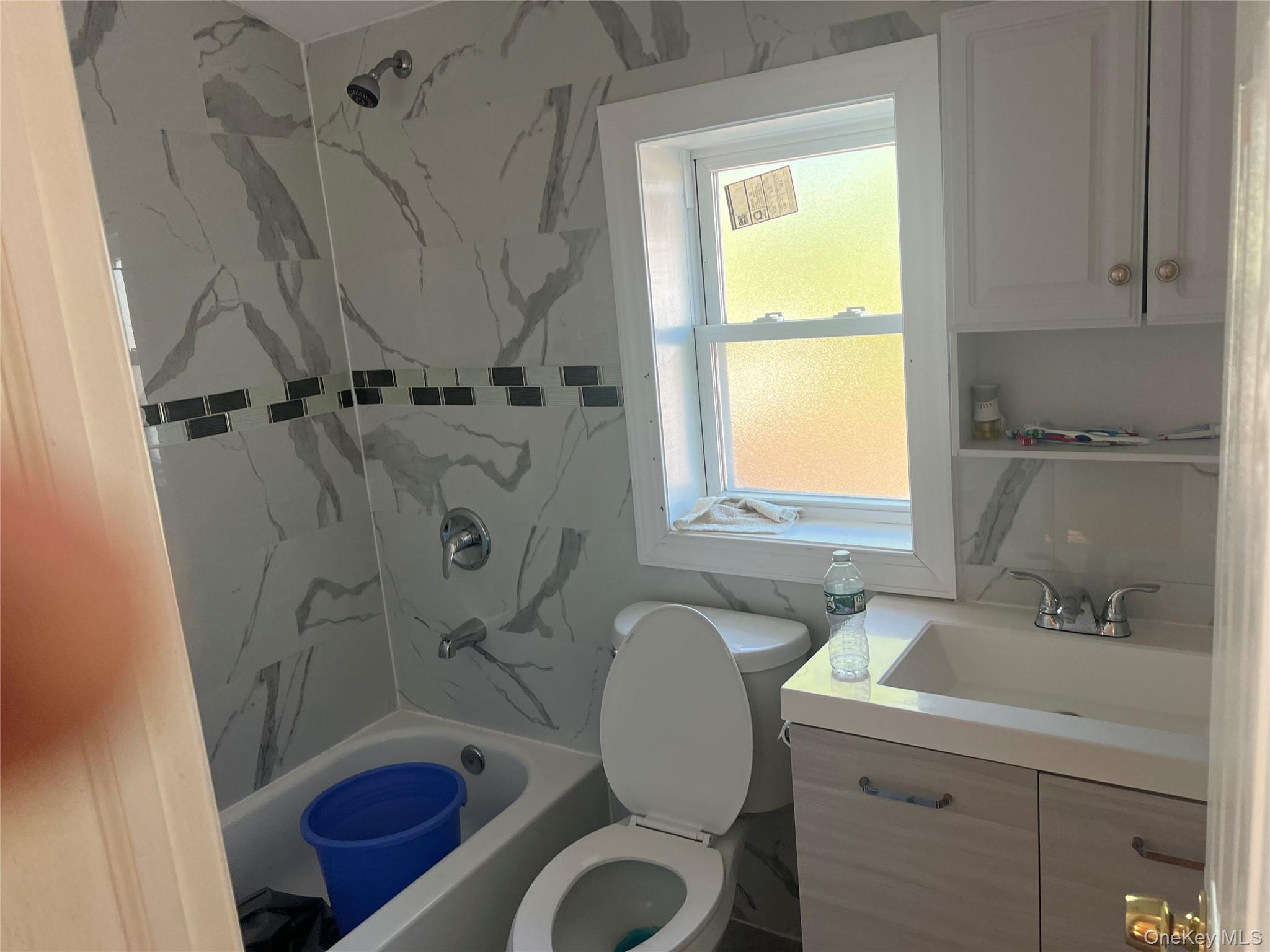 189-20 117th Road Queens, NY 11412 - Photo 20 of 26 a bathroom with a sink toilet a mirror and shower