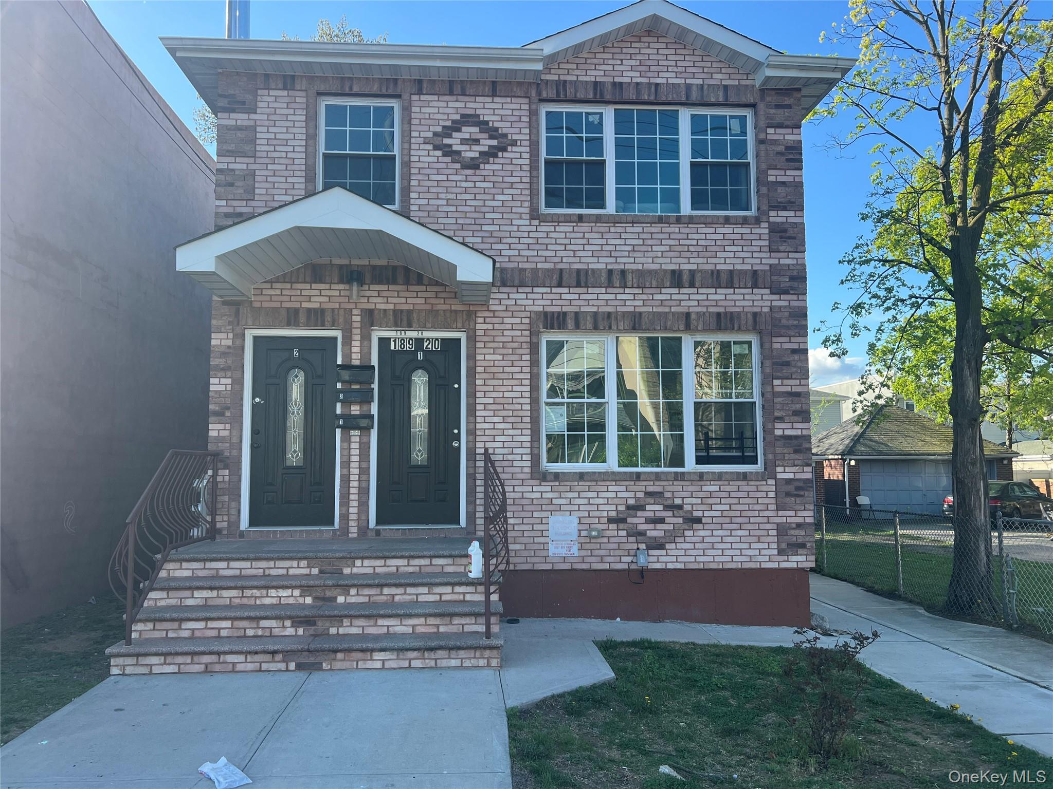 189-20 117th Road Queens, NY 11412 - Photo 2 of 26 a front view of a house with a yard
