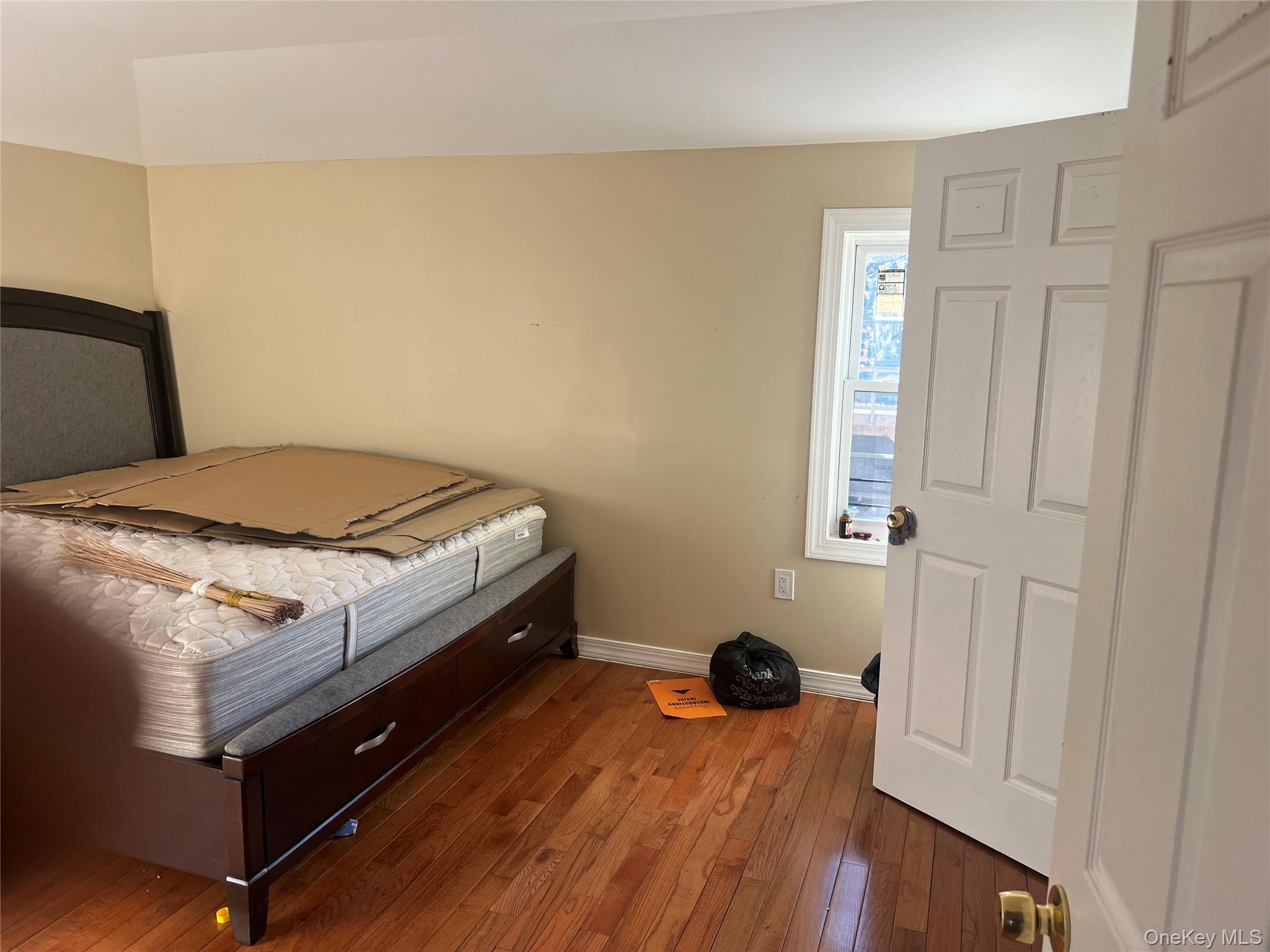 189-20 117th Road Queens, NY 11412 - Photo 22 of 26 a bed sitting in a bedroom next to a window