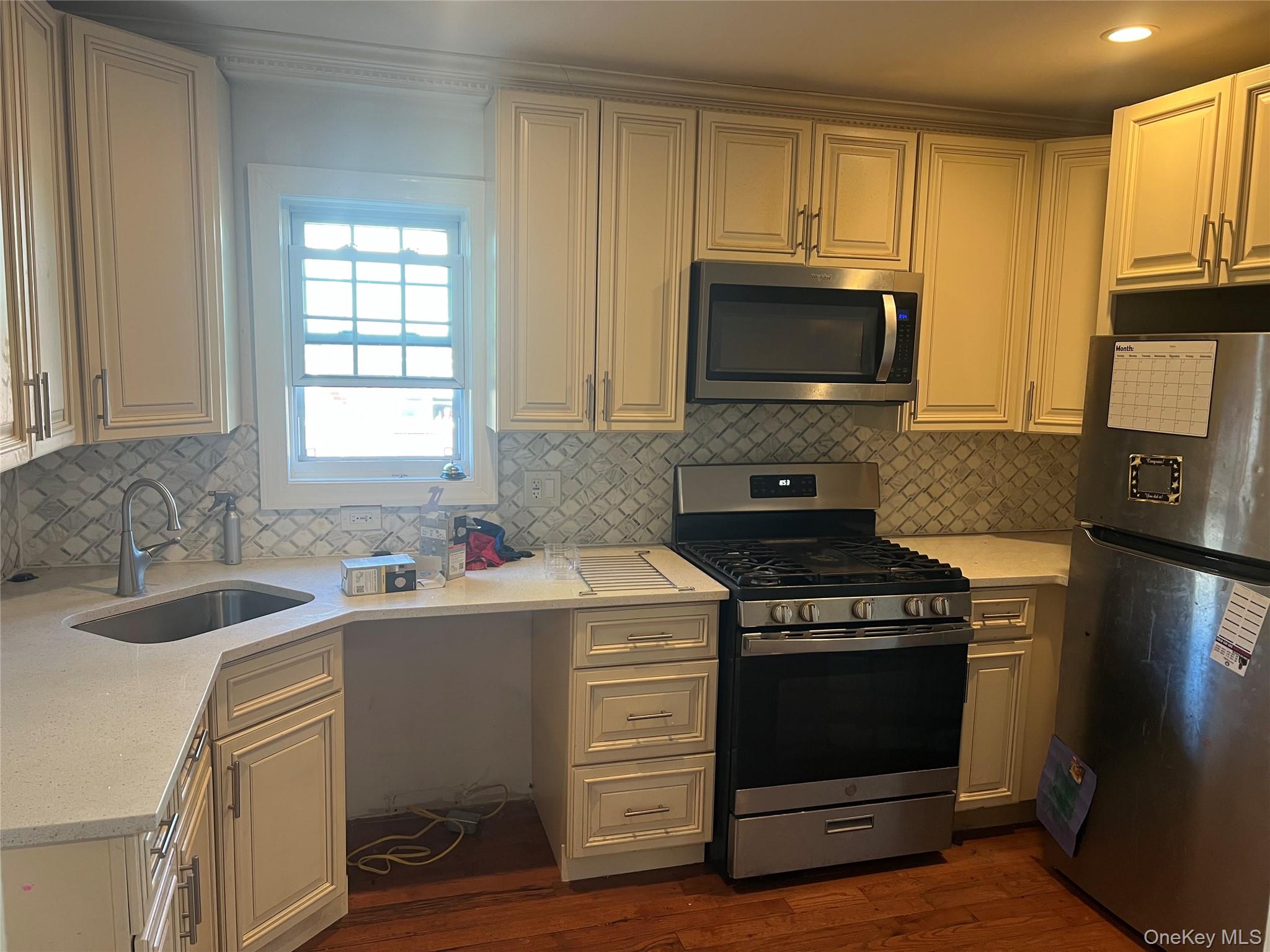 189-20 117th Road Queens, NY 11412 - Photo 8 of 26 a kitchen with a sink stove and microwave