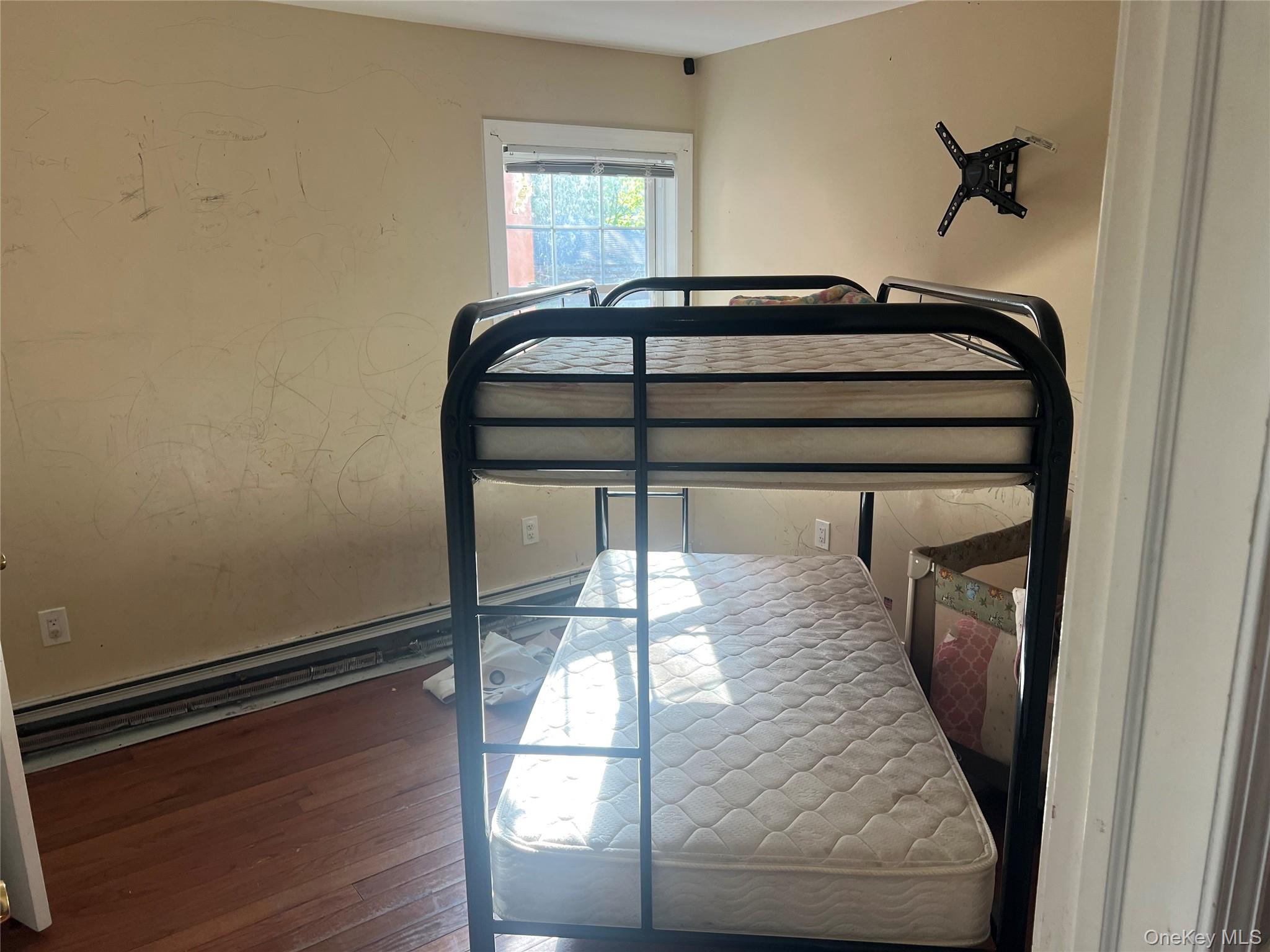 189-20 117th Road Queens, NY 11412 - Photo 10 of 26 a bedroom with a bed and wooden floor