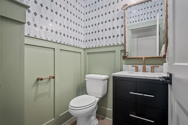 a bathroom with a sink toilet a mirror and shower