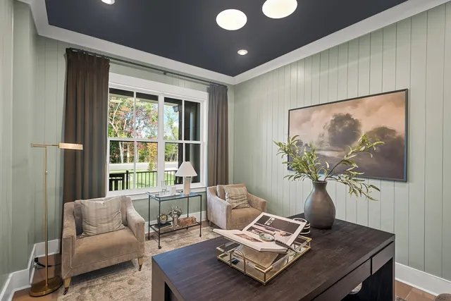 a living room with furniture and large windows