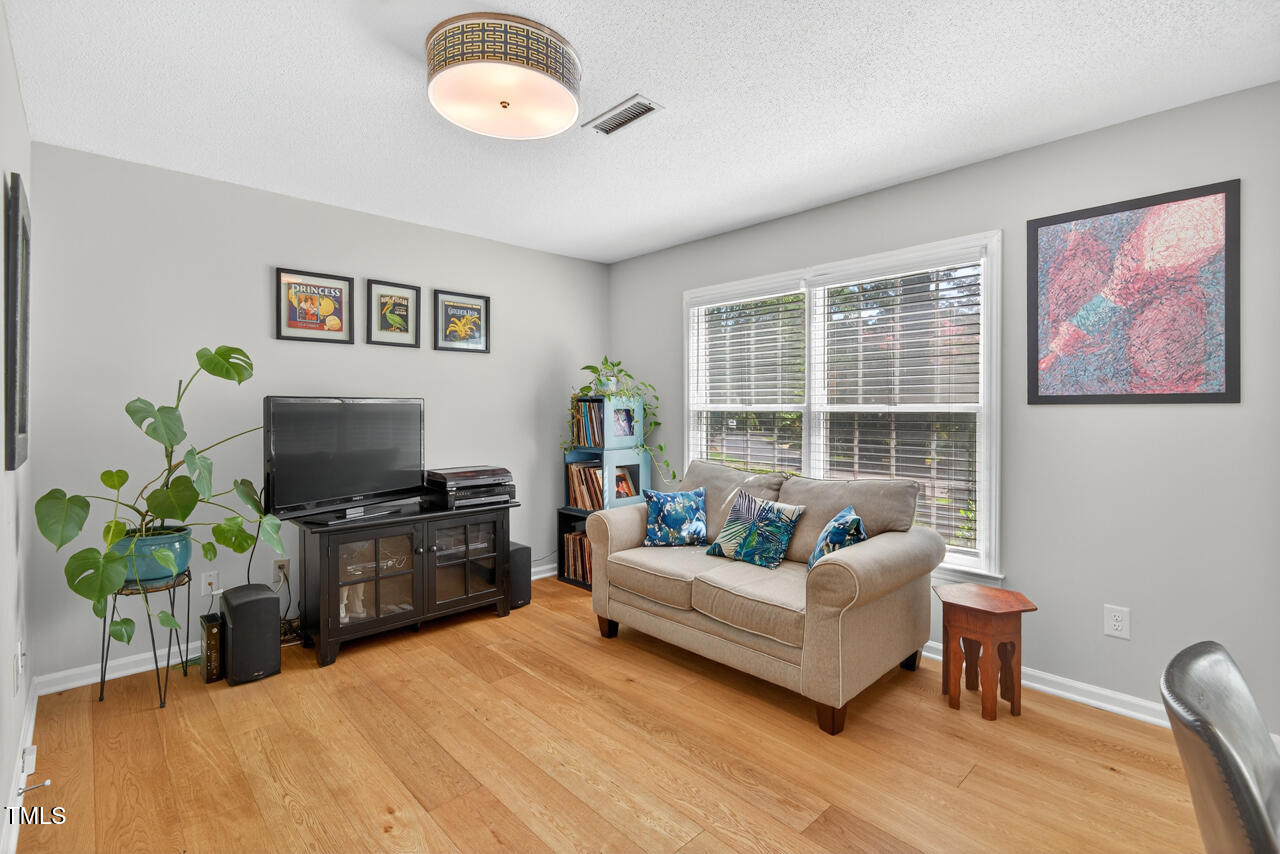 123 Weatherhill Point Carrboro, NC 27510 - Photo 15 of 25 a living room with furniture potted plant and a window