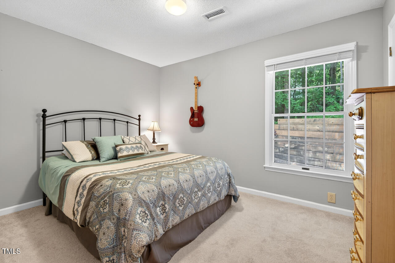123 Weatherhill Point Carrboro, NC 27510 - Photo 17 of 25 a bedroom with a bed and a window