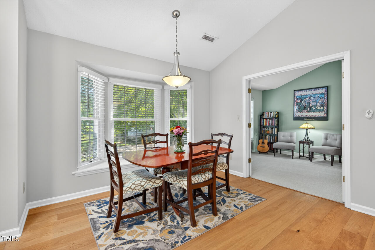 123 Weatherhill Point Carrboro, NC 27510 - Photo 5 of 25 a view of a dining room and livingroom with furniture wooden floor a rug and a chandelier