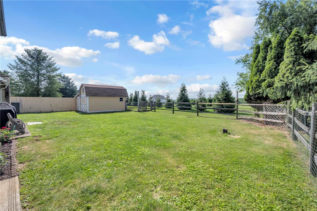 439 Cherry Hill Road Nazareth, PA 18064 - Photo 29 of 31 A spacious, verdant yard with a functional shed and rustic fencing.