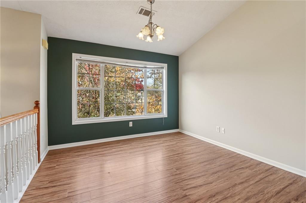 572 Casey's Crossing Winder, GA 30680 - Photo 2 of 31 a view of an empty room with wooden floor and a window