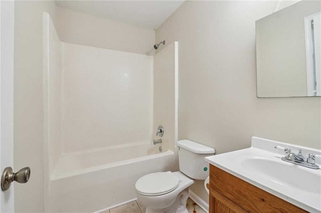 572 Casey's Crossing Winder, GA 30680 - Photo 23 of 31 a bathroom with a sink a toilet and shower