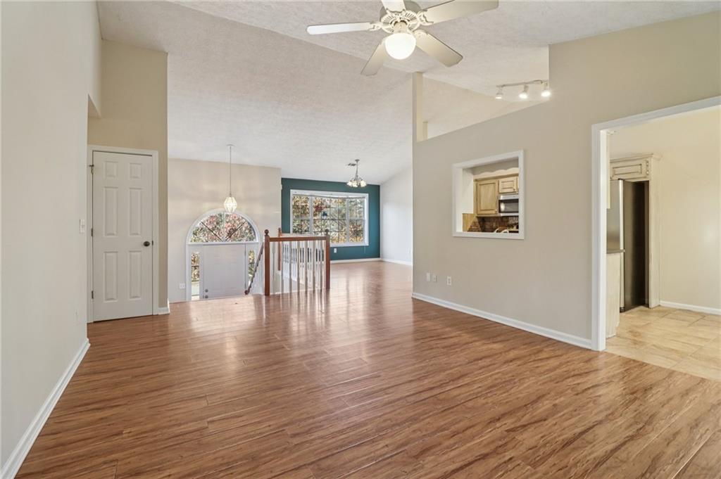 572 Casey's Crossing Winder, GA 30680 - Photo 6 of 31 a view of an empty room with wooden floor and a ceiling fan