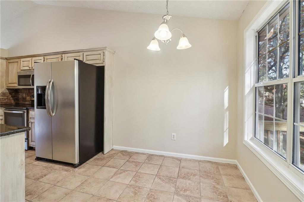 572 Casey's Crossing Winder, GA 30680 - Photo 9 of 31 a view of a kitchen with a refrigerator a sink and dishwasher