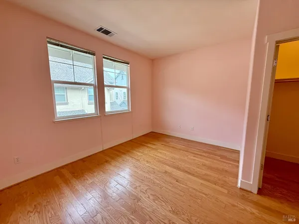 a view of an empty room with closet area