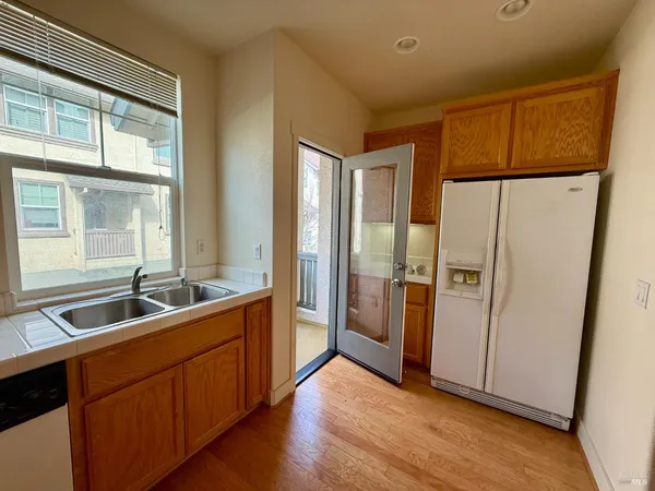 a kitchen with stainless steel appliances granite countertop a refrigerator and a sink
