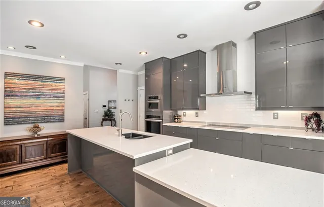 a room with a sink a counter and chairs