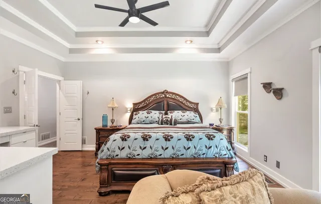 a bed sitting in a bedroom next to a window