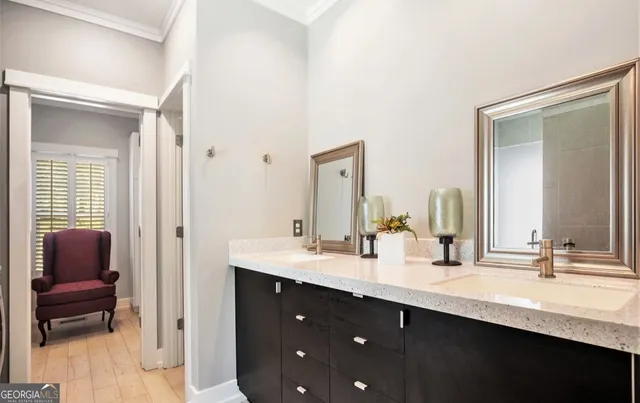 a bathroom with double vanity sinks and a mirror