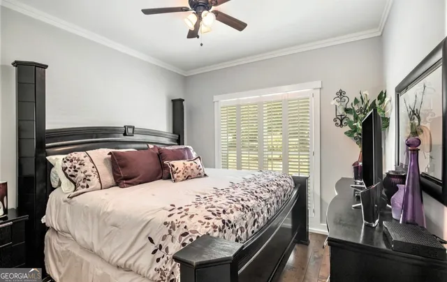 a bedroom with a large bed and a flat tv screen on dresser