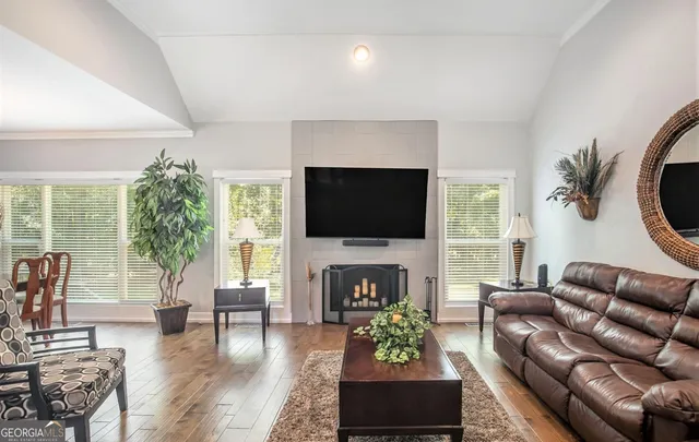 a living room with furniture fireplace and a flat screen tv