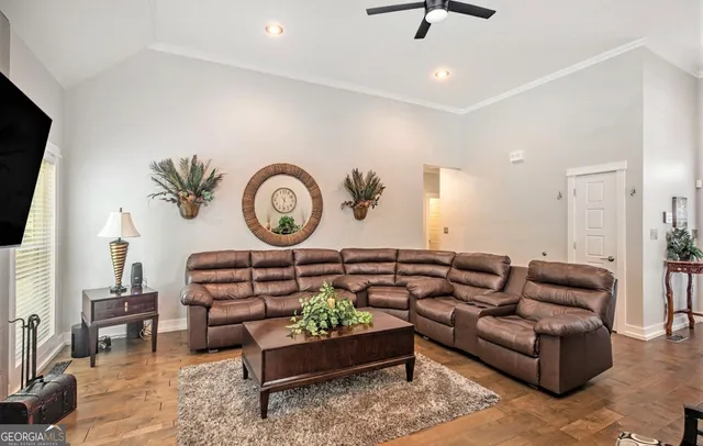 a living room with furniture a rug and a window