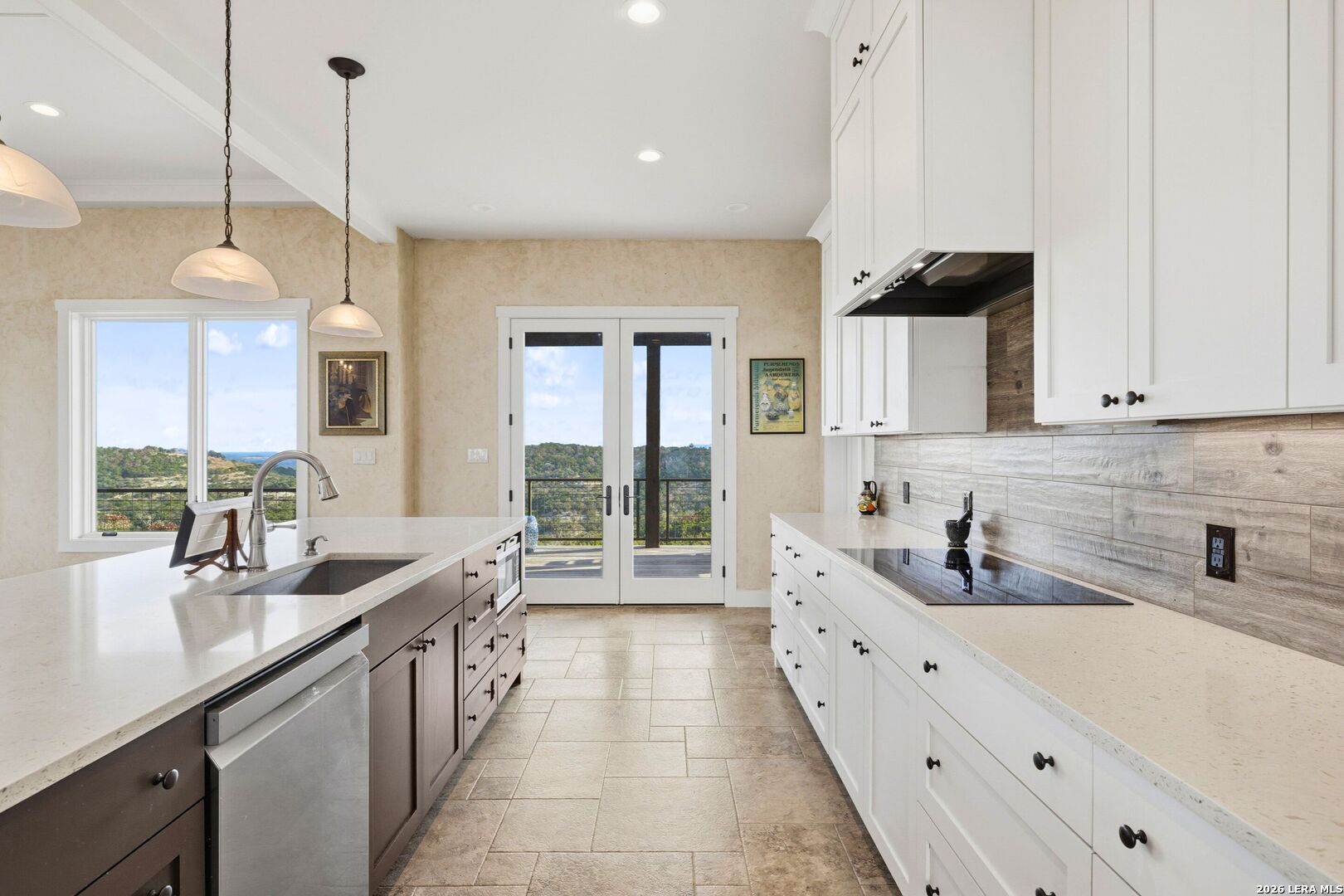 1600 Brushy Ridge Trail Blanco, TX 78606 - Photo 19 of 43 a large kitchen with kitchen island granite countertop a large counter top a sink stainless steel appliances and cabinets