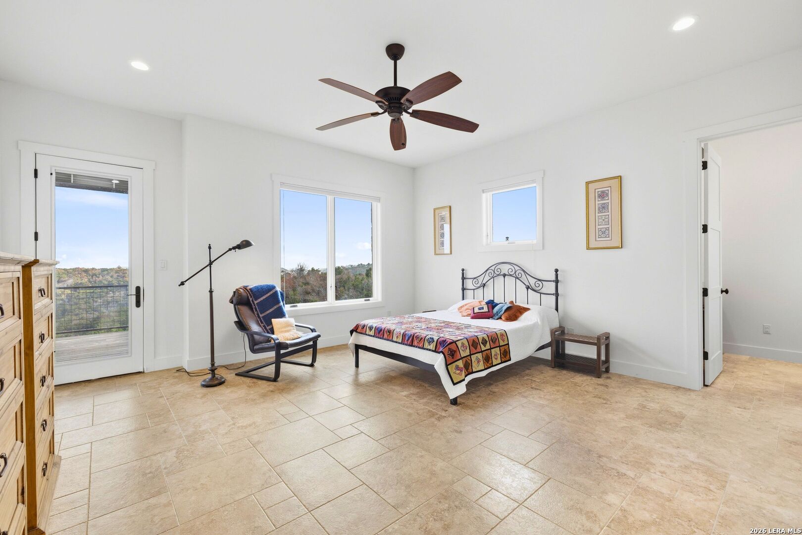 1600 Brushy Ridge Trail Blanco, TX 78606 - Photo 23 of 43 a bedroom with a bed and a chandelier
