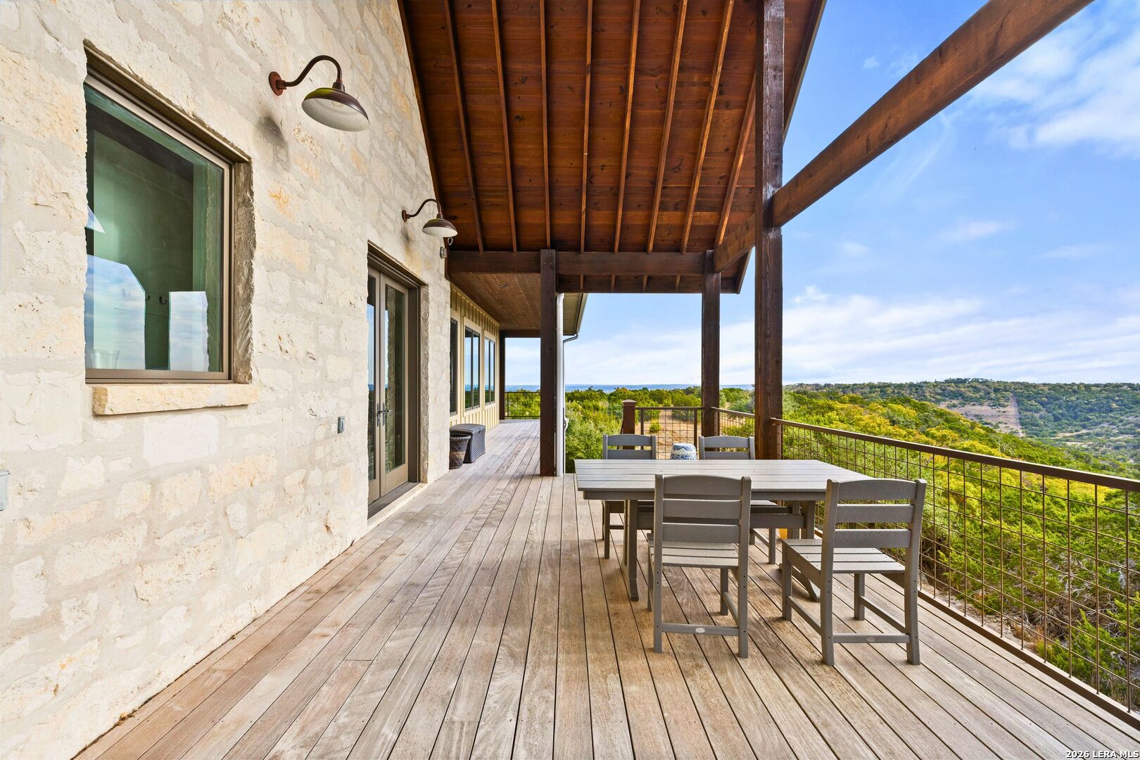 1600 Brushy Ridge Trail Blanco, TX 78606 - Photo 6 of 43 a view of a balcony with chairs and wooden floor