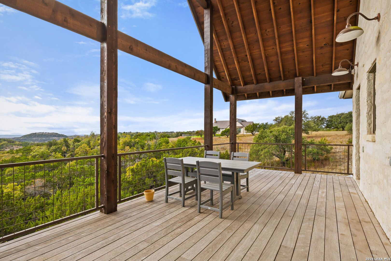 1600 Brushy Ridge Trail Blanco, TX 78606 - Photo 7 of 43 a view of a balcony with chairs and wooden floor
