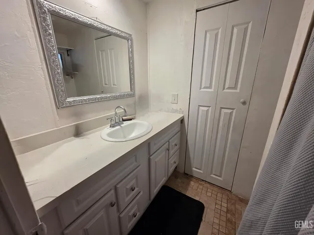 a bathroom with a double vanity sink and mirror