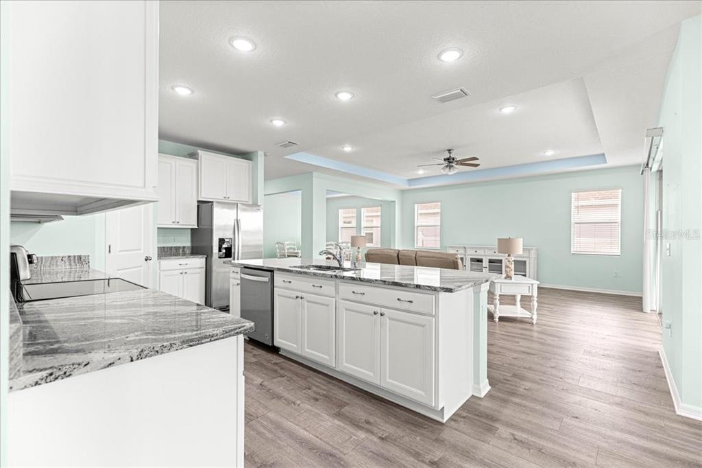 5851 Southwest 85th Place Ocala, FL 34476 - Photo 9 of 57 a kitchen with white cabinets appliances and wooden floor