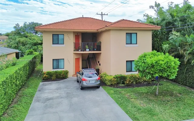 a front view of a house with a garden