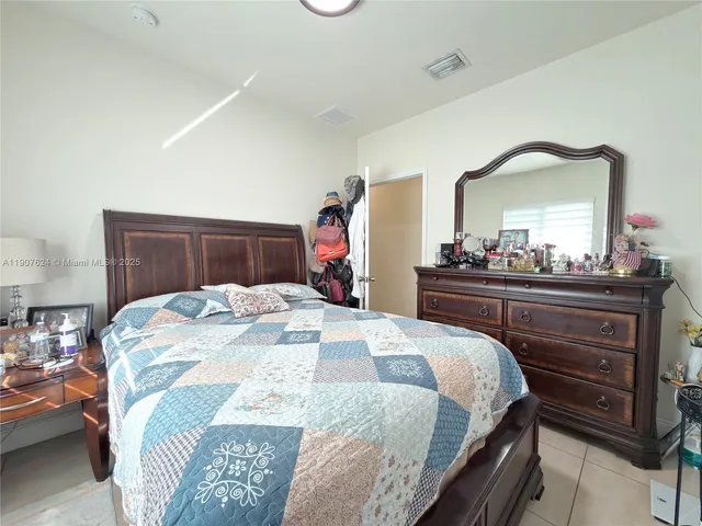 a bedroom with a bed and a dresser