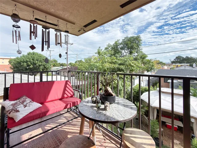 a balcony with table and chairs