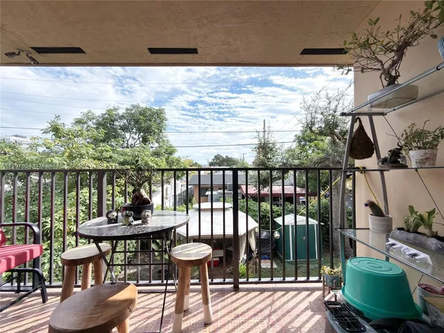 a view of a balcony with chairs and wooden floor