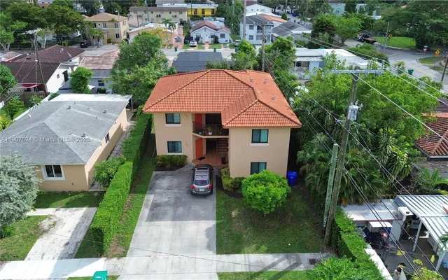 a aerial view of a house with yard and plants