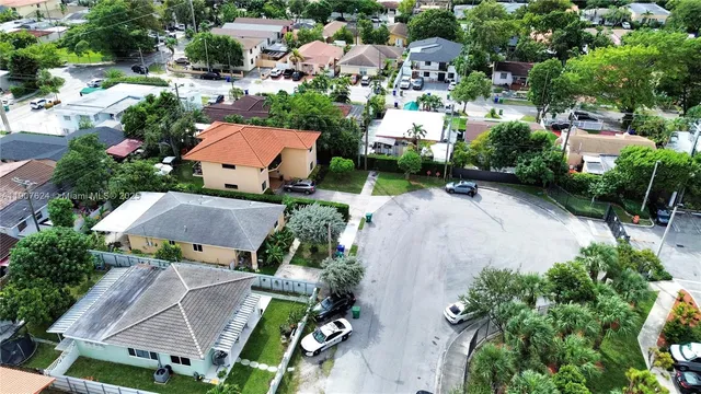 an aerial view of multiple houses with yard