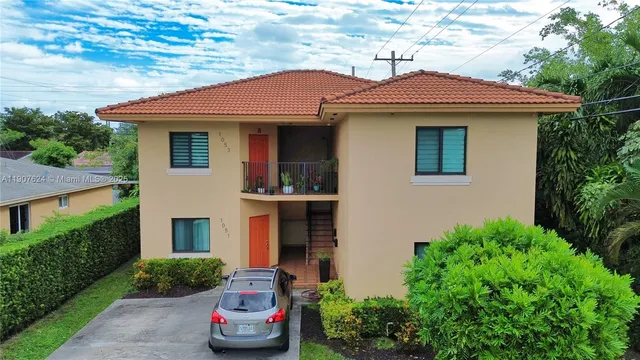 a front view of a house with a garden