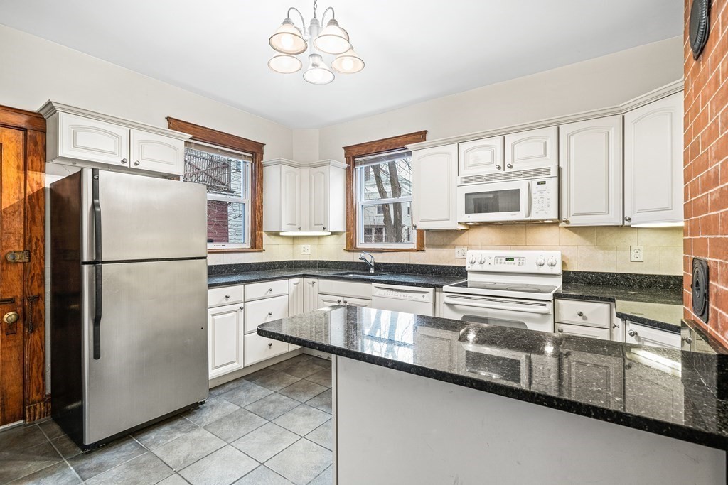 73 Halifax Street Boston, MA 02130 - Photo 15 of 18 a kitchen with stainless steel appliances a refrigerator sink and microwave