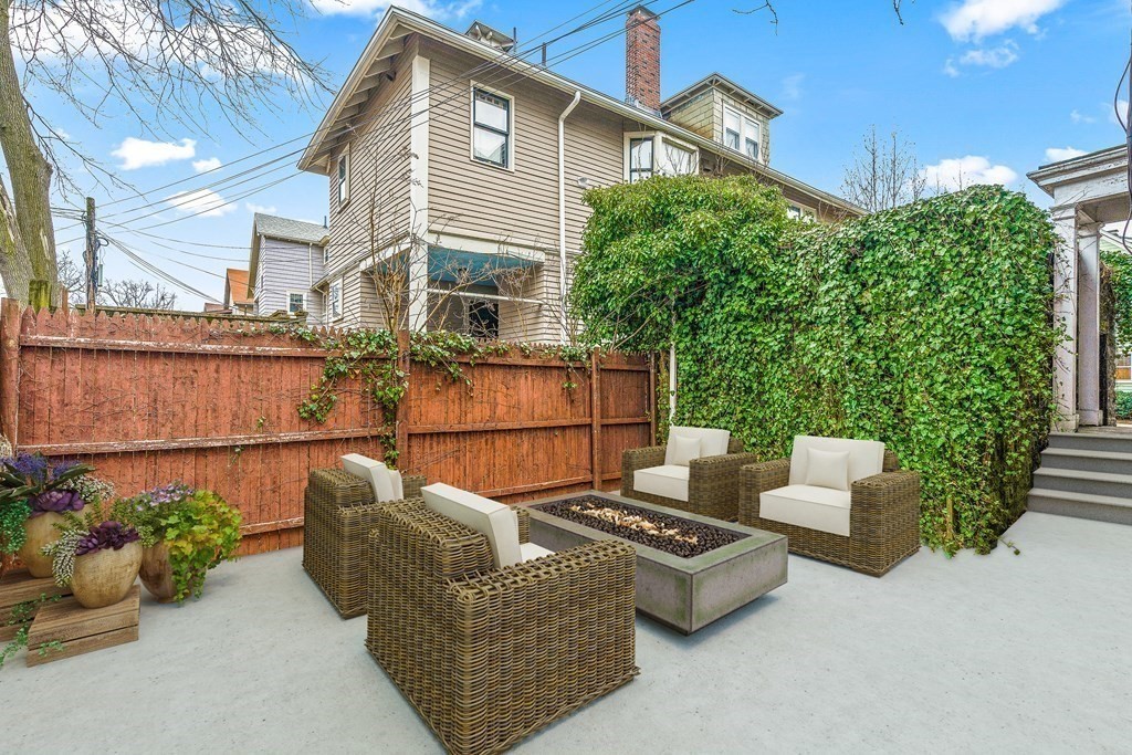 73 Halifax Street Boston, MA 02130 - Photo 17 of 18 a view of a patio with couches table and chairs and potted plants